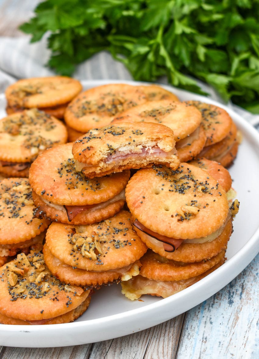ritz cracker party sandwiches stacked on a white plate