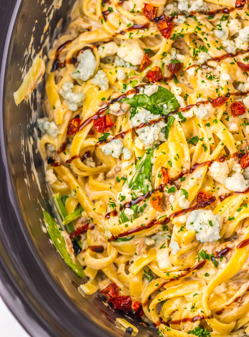copycat steak gorgonzola pasta in the black bowl of a slow cooker