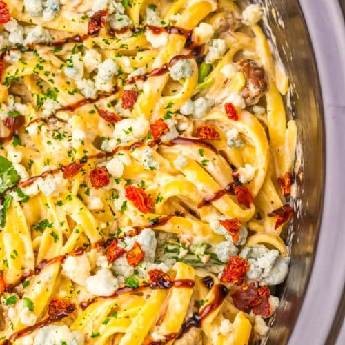 copycat steak gorgonzola pasta in the black bowl of a slow cooker