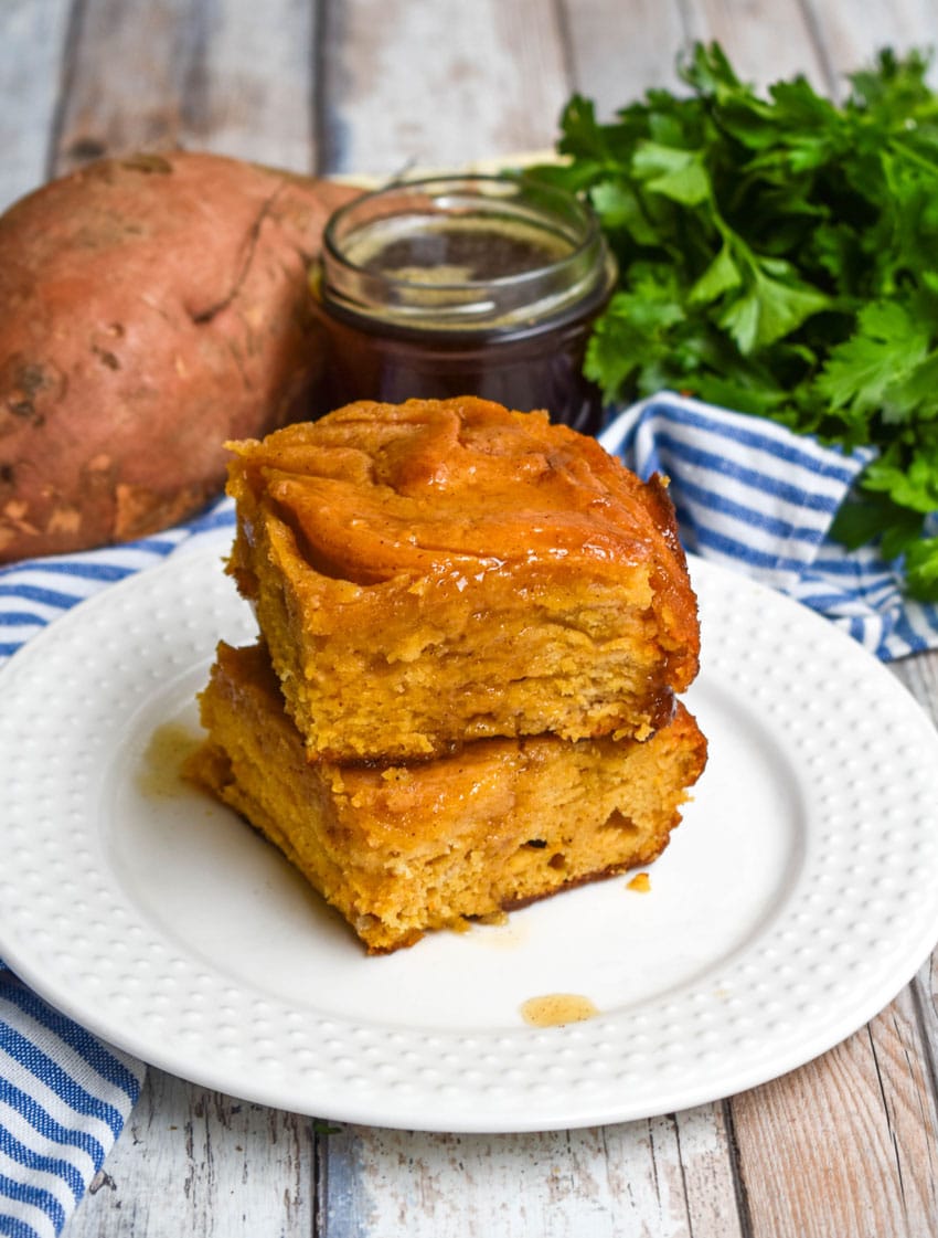 two sweet potato butter swim biscuits stacked on a small white plate