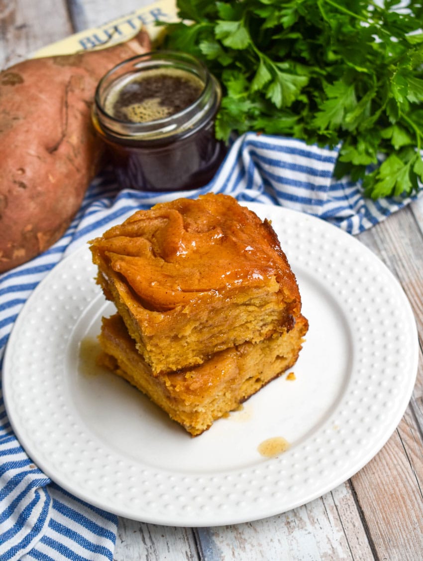 two sweet potato butter swim biscuits stacked on a small white plate